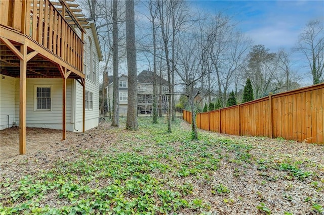 view of yard with fence and a deck