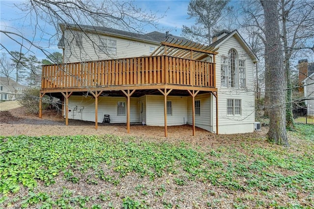 rear view of property featuring a wooden deck