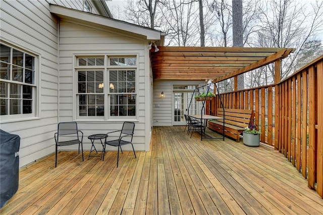 wooden terrace with outdoor dining area and a pergola
