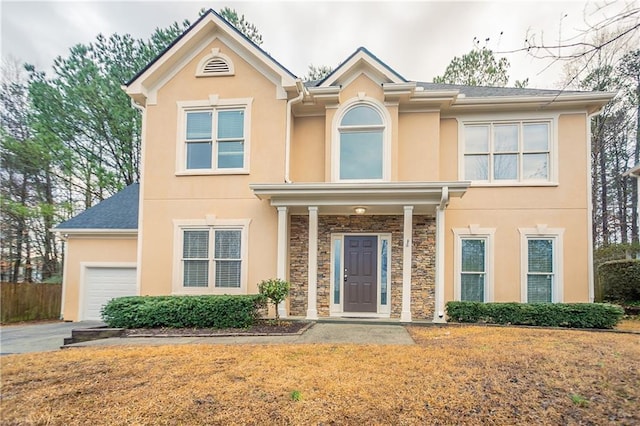 view of front of home with a garage and a front lawn