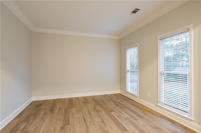 unfurnished room featuring crown molding and light wood-type flooring