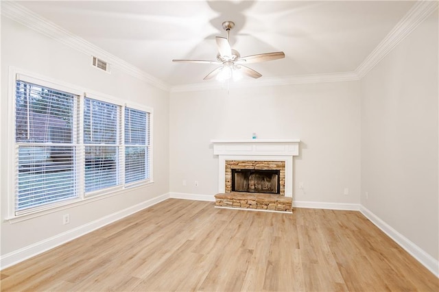 unfurnished living room featuring ornamental molding, a fireplace, light hardwood / wood-style floors, and ceiling fan