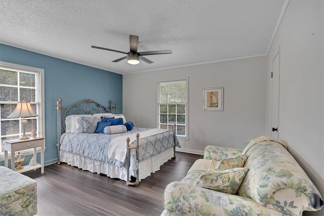 bedroom featuring dark hardwood / wood-style flooring, crown molding, a textured ceiling, and ceiling fan