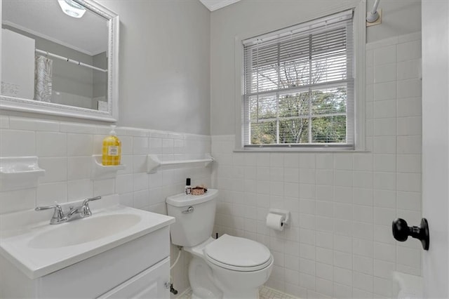 bathroom featuring vanity, toilet, tile walls, and curtained shower