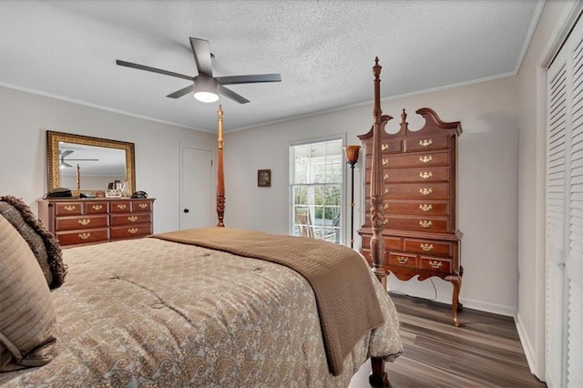 bedroom featuring dark hardwood / wood-style floors, a closet, ornamental molding, a textured ceiling, and ceiling fan