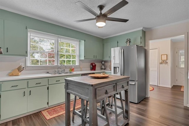 kitchen featuring sink, a textured ceiling, stainless steel fridge with ice dispenser, and dark hardwood / wood-style floors