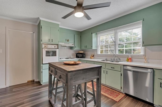 kitchen featuring dark hardwood / wood-style flooring, green cabinetry, and white appliances