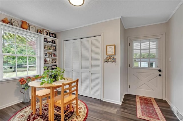 dining space with ornamental molding, dark hardwood / wood-style floors, and a textured ceiling