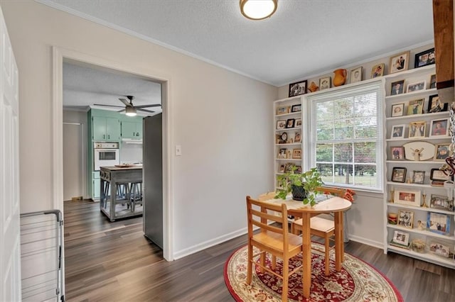 dining area featuring dark wood-type flooring, a textured ceiling, and ceiling fan