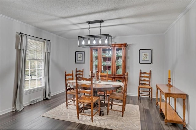 dining space with crown molding, a textured ceiling, and dark hardwood / wood-style floors