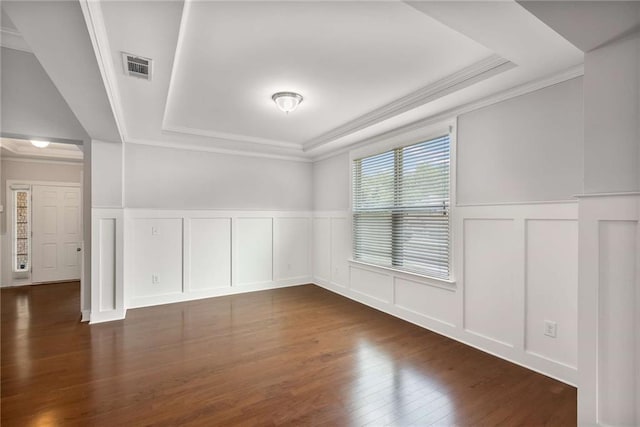 1374 Highland Wood Ct, Auburn, GA 30011 - unfurnished room with a tray ceiling, a decorative wall, ornamental molding, wood finished floors, and a wainscoted wall