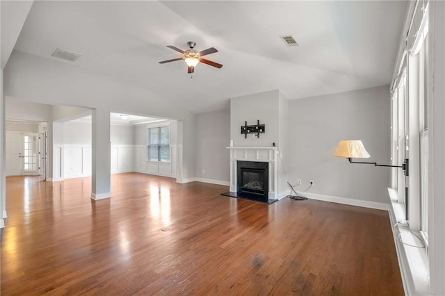 1374 Highland Wood Ct, Auburn, GA 30011 - unfurnished living room with vaulted ceiling, ceiling fan, wood finished floors, a glass covered fireplace, and plenty of natural light