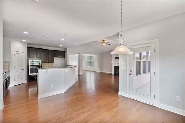 1374 Highland Wood Ct, Auburn, GA 30011 - kitchen featuring double oven, open floor plan, ceiling fan, tasteful backsplash, and recessed lighting
