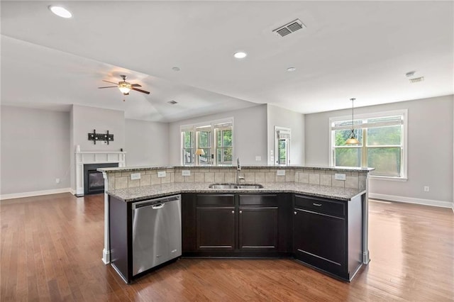 1374 Highland Wood Ct, Auburn, GA 30011 - kitchen with stainless steel dishwasher, a sink, open floor plan, baseboards, and dark wood-style floors