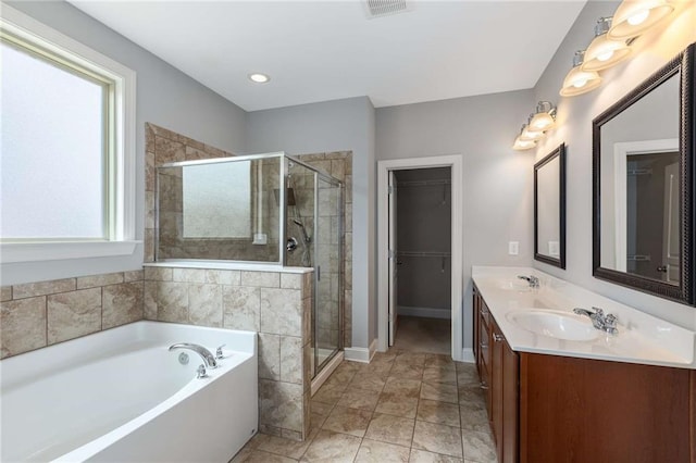 1374 Highland Wood Ct, Auburn, GA 30011 - full bathroom featuring a garden tub, double vanity, a shower stall, and a spacious closet