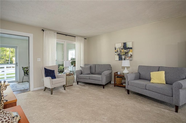 carpeted living room featuring a textured ceiling