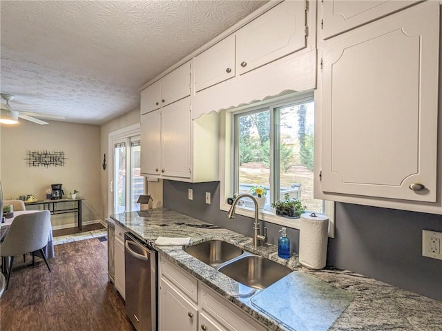 kitchen featuring a wealth of natural light, a textured ceiling, sink, and dark hardwood / wood-style floors