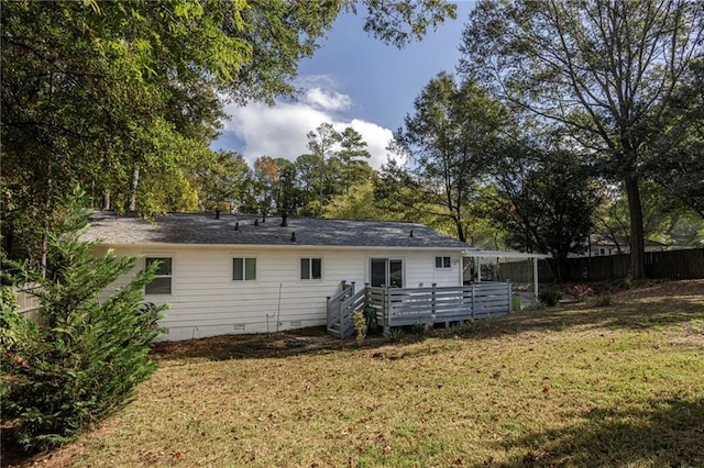 rear view of house featuring a yard