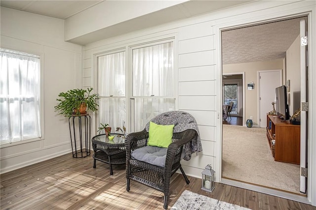 living area with hardwood / wood-style flooring