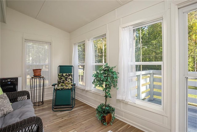 sunroom featuring lofted ceiling