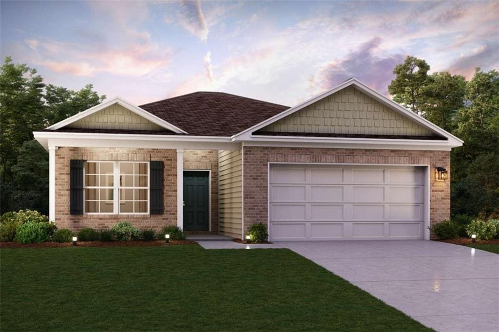 152 Pinehurst Ct, Dublin, GA 31021 - view of front facade with brick siding, driveway, a front lawn, and an attached garage