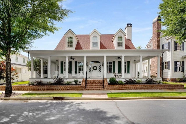 view of front of home featuring ceiling fan and a porch