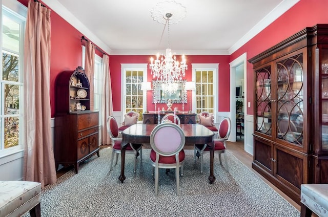 dining area featuring ornamental molding and a notable chandelier