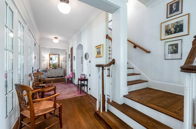 interior space with crown molding and dark wood-type flooring