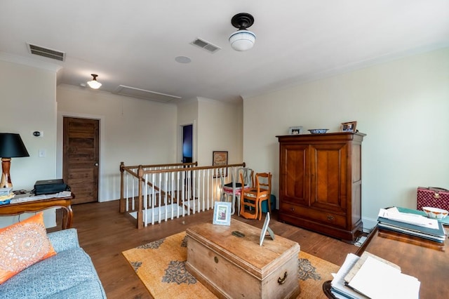 living room with dark wood-type flooring and crown molding