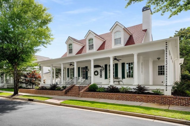 cape cod house with a porch and ceiling fan