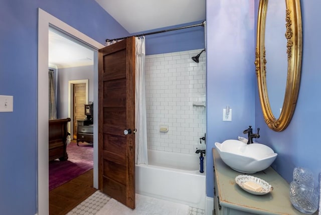 bathroom featuring vanity, wood-type flooring, and shower / bath combo with shower curtain