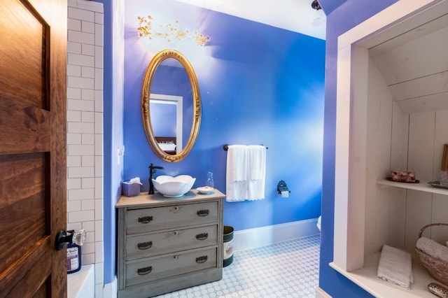 bathroom with vanity and wooden walls