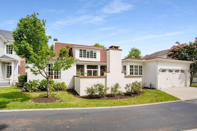 view of front of home featuring a garage and a front lawn