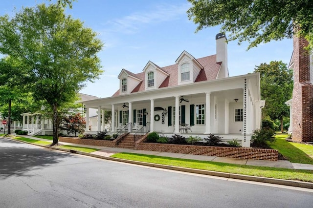 new england style home featuring a porch