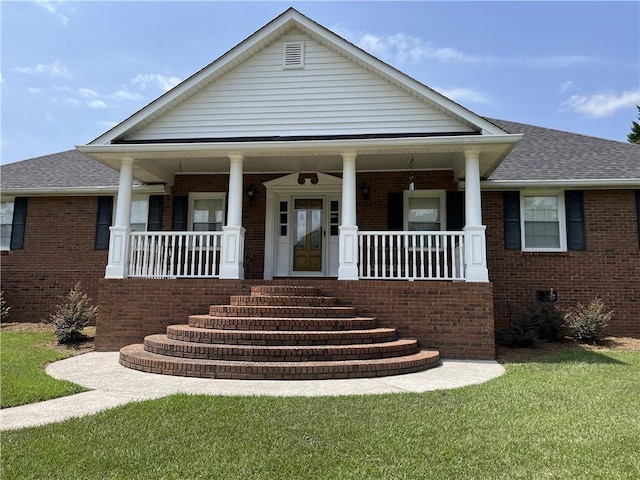 view of front of home with a porch and a front yard