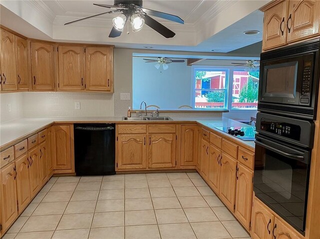 kitchen with ornamental molding, a raised ceiling, sink, black appliances, and light tile patterned floors