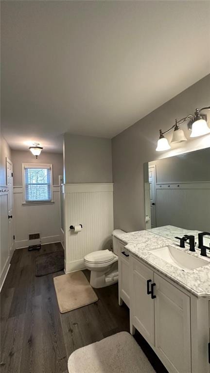 bathroom featuring vanity, hardwood / wood-style floors, and toilet