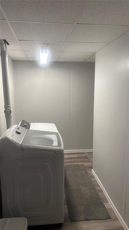 laundry room featuring washer and dryer and dark hardwood / wood-style floors