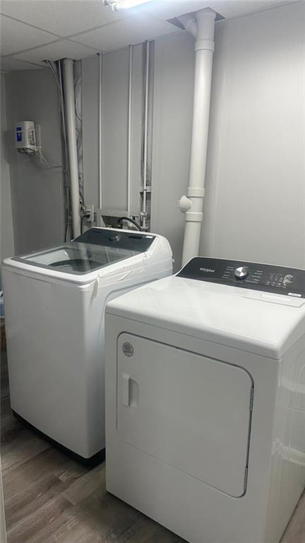 washroom with dark hardwood / wood-style floors and washer and dryer