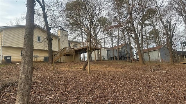 view of yard with cooling unit and a wooden deck