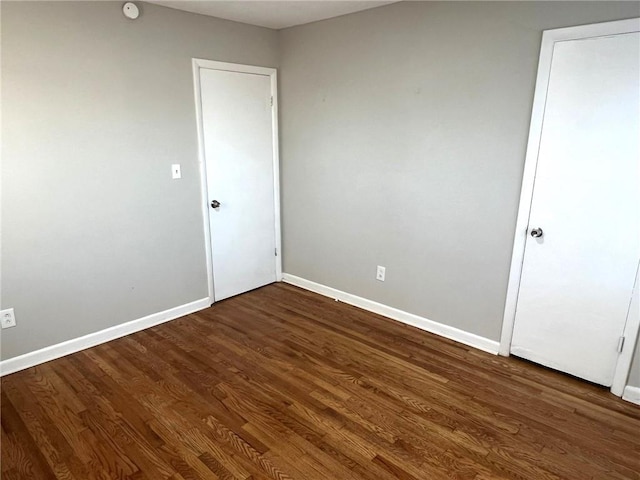 unfurnished bedroom featuring dark wood-type flooring