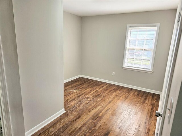 spare room featuring dark hardwood / wood-style flooring