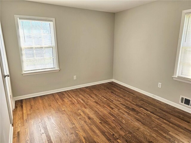 empty room with hardwood / wood-style flooring