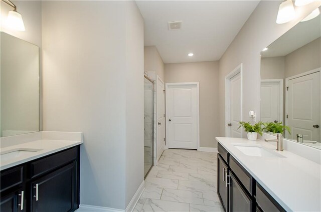 bathroom with vanity and a shower with door