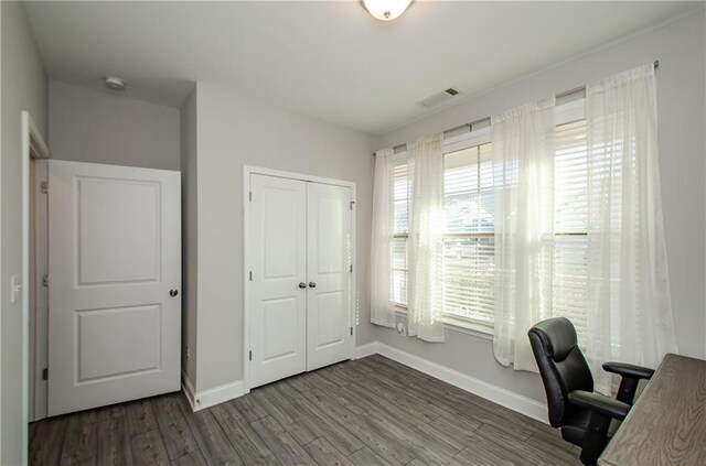 home office with hardwood / wood-style flooring and a healthy amount of sunlight