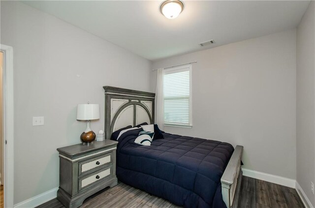 bedroom with hardwood / wood-style floors