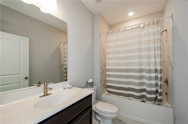 full bathroom with shower / bath combo, vanity, and toilet