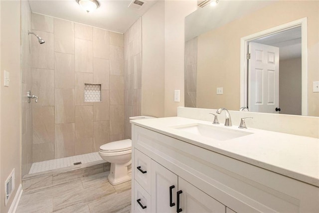 1207 Ellington Dr, Morrow, GA 30260 - full bathroom featuring vanity, toilet, and tiled shower