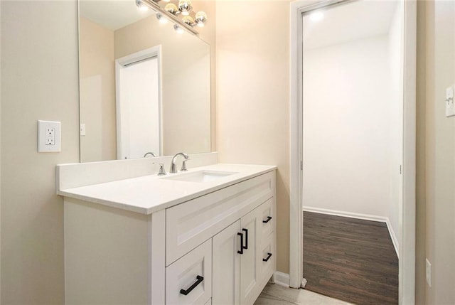 1207 Ellington Dr, Morrow, GA 30260 - bathroom with vanity, baseboards, and wood finished floors