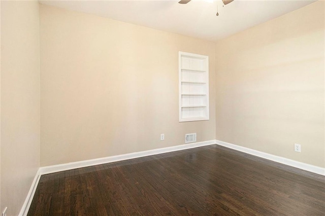 1207 Ellington Dr, Morrow, GA 30260 - unfurnished room featuring dark wood-type flooring, ceiling fan, baseboards, and built in features